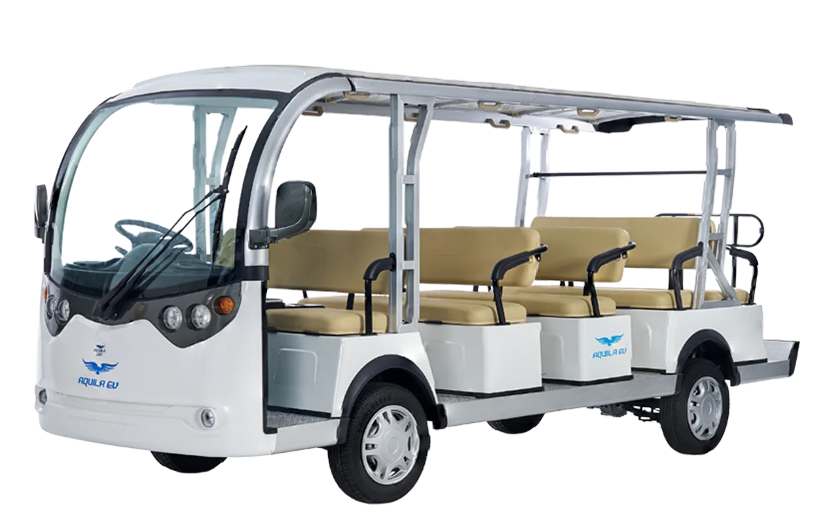 A white electric mini bus with open sides and multiple rows of beige seating, parked against a plain background.